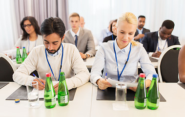 Image showing businesspeople with papers at conference