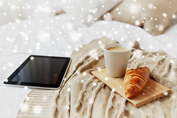 Image showing tablet pc, coffee and croissant on bed at home