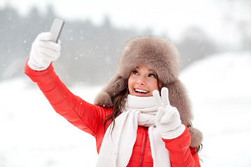 Image showing happy woman taking selfie outdoors in winter