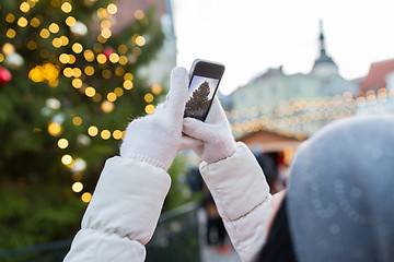 Image showing hands with smartphone photographing christmas tree