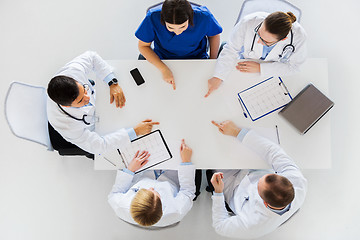 Image showing group of doctors with cardiograms working at table