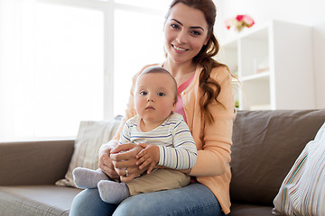 Image showing happy young mother with little baby at home