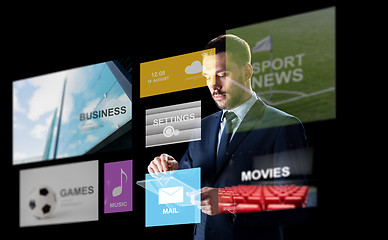 Image showing businessman with tablet pc and multimedia