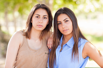 Image showing Two Beautiful Ethnic Twin Sisters Portrait Outdoors.