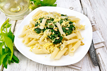 Image showing Pasta penne with spinach and nuts on board