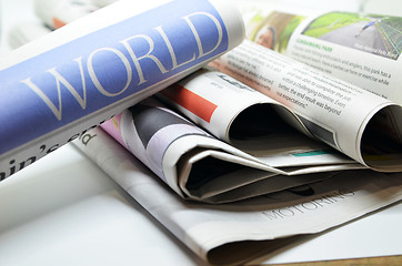 Image showing Rolled newspaper with the world news