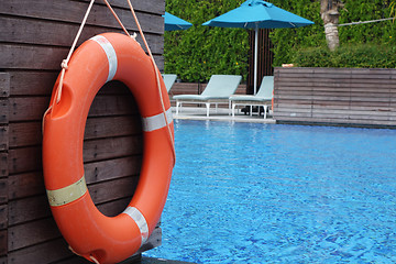 Image showing Life ring orange color hanging at wall