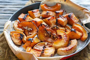 Image showing Pumpkin cut into pieces baked in honey.