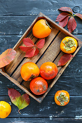 Image showing Juicy persimmon in a wooden box.