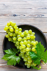 Image showing Juicy white grapes in a wooden bowl.