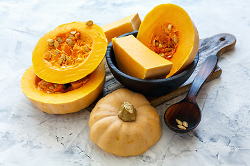 Image showing Pumpkin sliced on an old wooden board.