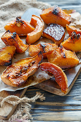 Image showing Slices of pumpkin roasted with honey on a parchment.