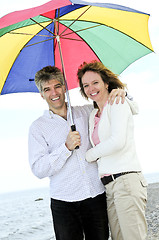 Image showing Happy mature couple with umbrella