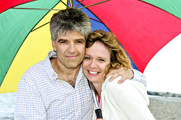 Image showing Happy mature couple with umbrella