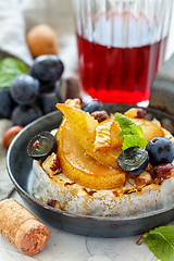 Image showing Baked camembert with pears and grapes.