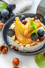 Image showing Skillet with baked camembert,caramelized pears and grapes.