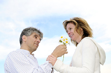 Image showing Mature romantic couple with flowers