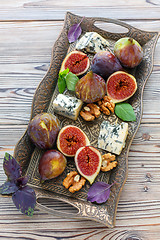 Image showing Blue cheese and ripe figs on a bronze tray.