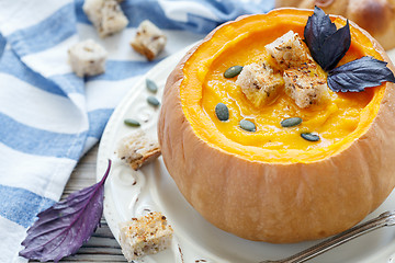 Image showing Pumpkin soup with croutons in a pumpkin closeup.