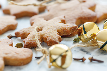 Image showing Gingerbread Christmas toys and golden bells close-up.