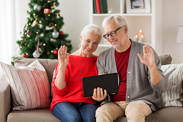 Image showing happy senior couple with tablet pc at christmas