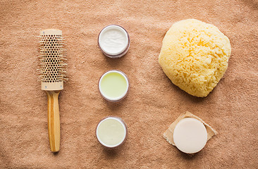 Image showing hair brush, cream, sponge, soap bar and bath towel