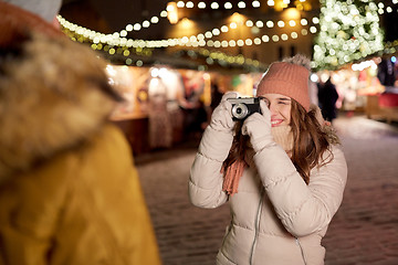 Image showing woman with camera photographing man at christmas