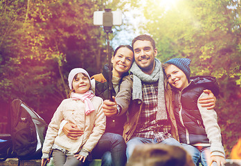 Image showing family with smartphone taking selfie near campfire