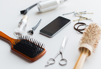 Image showing smartphone, scissors, brushes and other hair tools