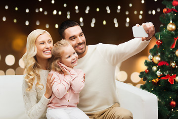 Image showing family taking selfie with smartphone at christmas