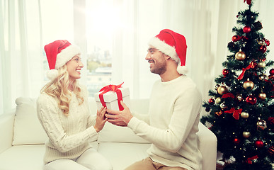 Image showing happy couple at home with christmas gift box