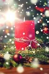 Image showing fir branch wreath with candle on wooden table