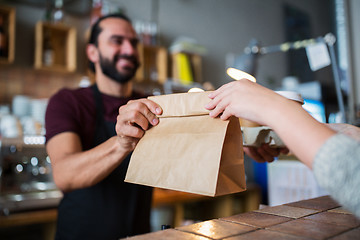 Image showing man or bartender serving customer at coffee shop