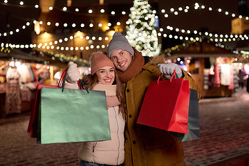 Image showing happy couple at with shopping bags in winter