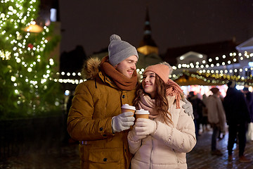 Image showing happy young couple with coffee at christmas market