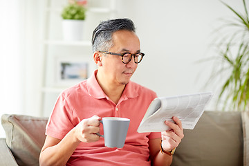 Image showing man drinking coffee and reading newspaper at home