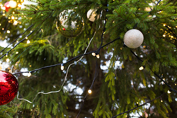 Image showing close up of fir with christmas tree toys outdoors