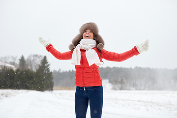 Image showing happy woman in winter fur hat having fun outdoors