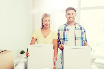 Image showing smiling couple with big boxes moving to new home