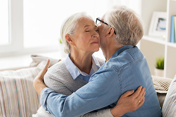 Image showing happy senior couple hugging at home