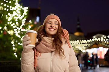Image showing happy young woman with coffee at christmas market