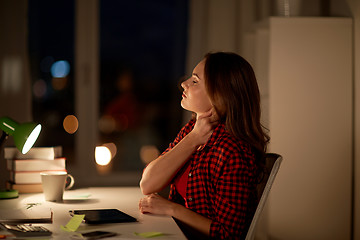 Image showing tired student or woman touching neck at night home