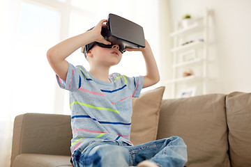 Image showing little boy in vr headset or 3d glasses at home