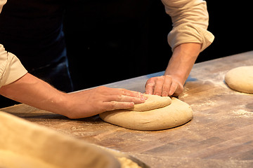 Image showing chef or baker cooking dough at bakery