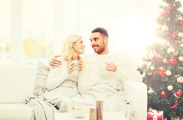 Image showing happy couple at home with christmas tree