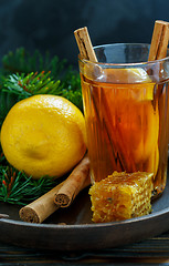 Image showing Hot tea with spices and lemon on a wooden tray.