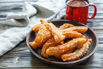 Image showing Dish with churros and hot chocolate.