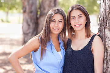 Image showing Two Beautiful Ethnic Twin Sisters Portrait Outdoors.