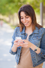 Image showing Beautiful Young Ethnic Woman Using Her Smartphone Outside.