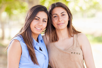 Image showing Two Beautiful Ethnic Twin Sisters Portrait Outdoors.